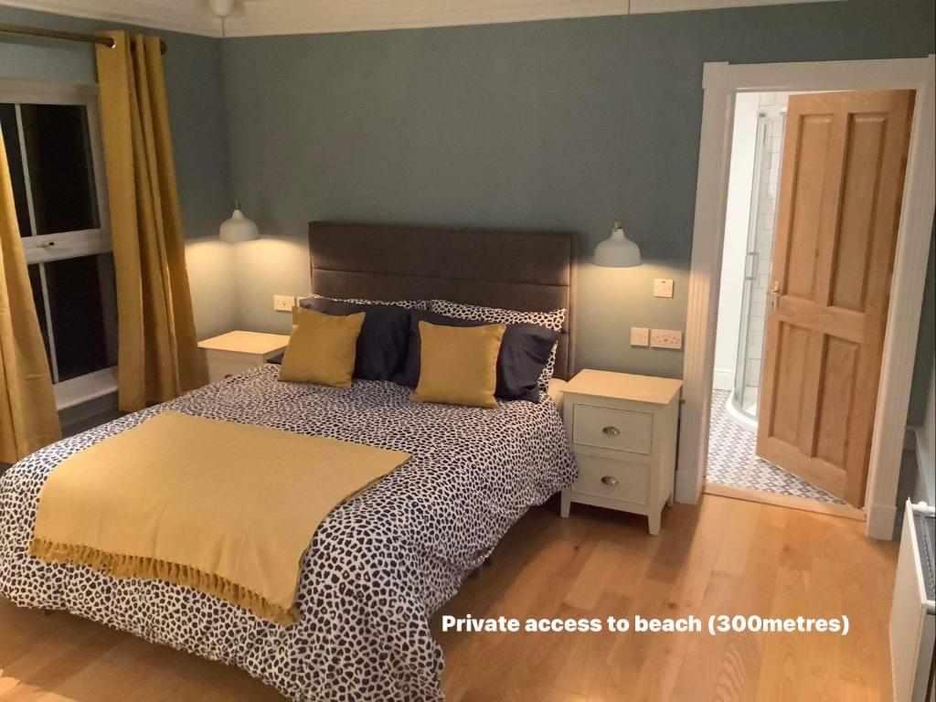 a bedroom with a large bed with yellow pillows at Puffin Lodge Accomodation in Killybegs