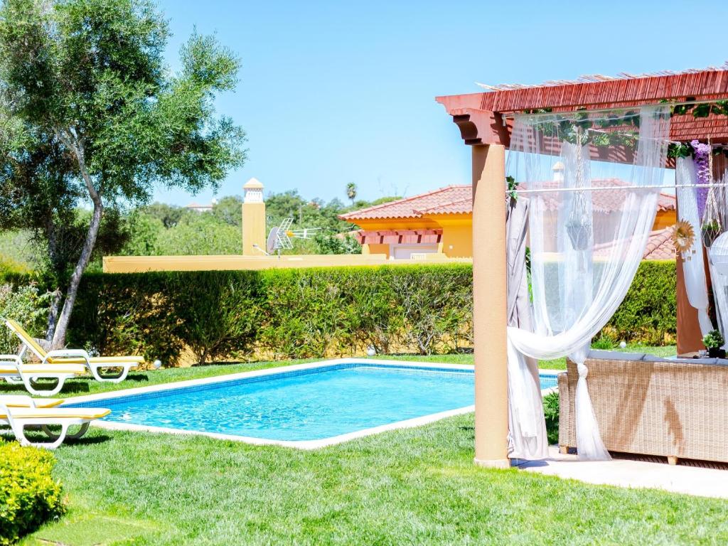 a swimming pool in the yard of a villa at Vilamoura ZEN Garden, private 3bdr vila with pool in Vilamoura