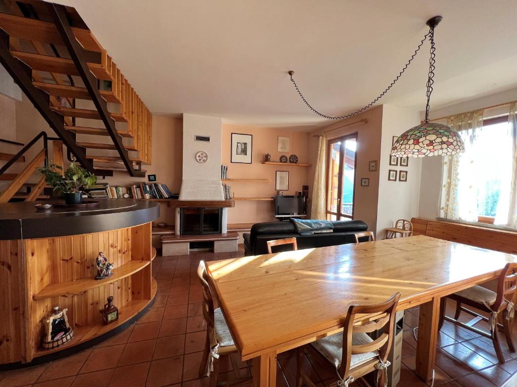 a dining room and living room with a wooden table at GIULIO in Fanano