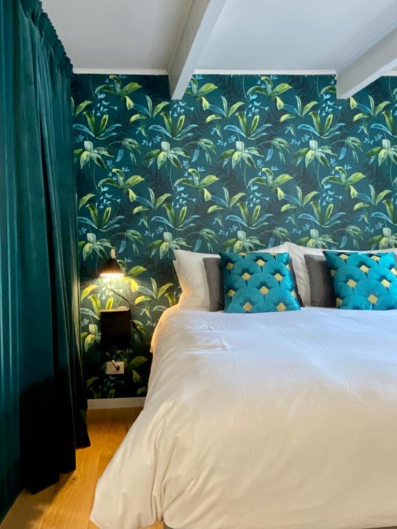 a bedroom with a large bed with a blue and green wall at Paradise Penthouse Suite Amazing View in Rome