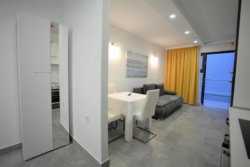 a living room with a white table and a couch at Eluize Inn Dubrovnik in Dubrovnik