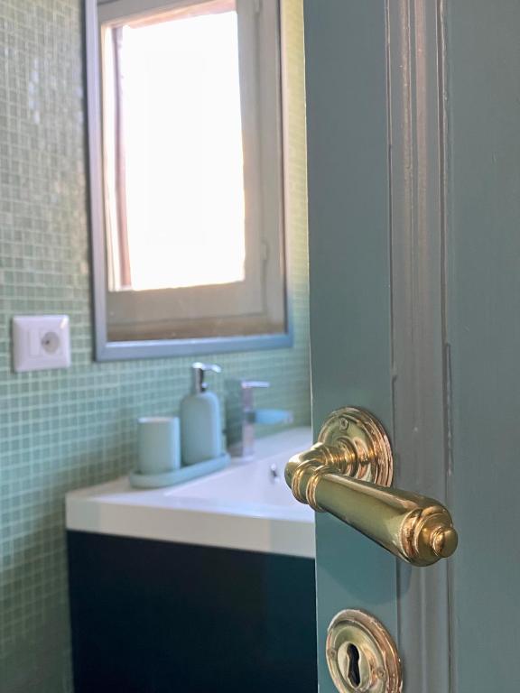 a bathroom with a sink and a door with a mirror at Paradise Penthouse Suite Amazing View in Rome