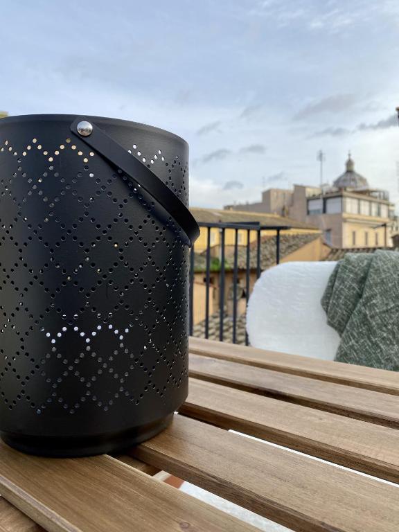 a black pot sitting on top of a balcony at Paradise Penthouse Suite Amazing View in Rome