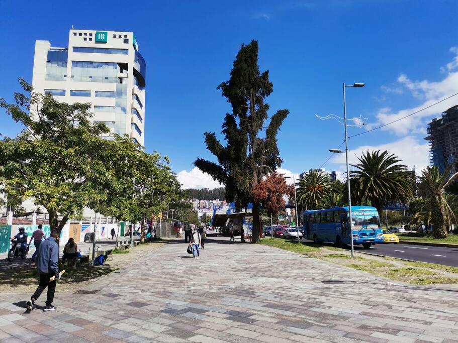 a group of people walking down a street with a bus at Dormitorio Independiente in Quito