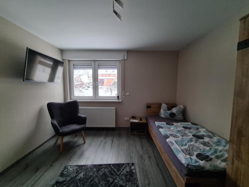 Postel nebo postele na pokoji v ubytování Pension Im Wiesengrund Steinau Marborn