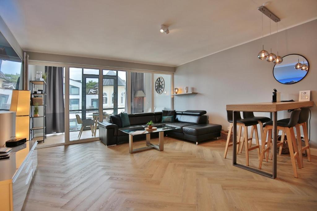 a living room with a couch and a table at Seaside Seaside Appartement 18 in Timmendorfer Strand