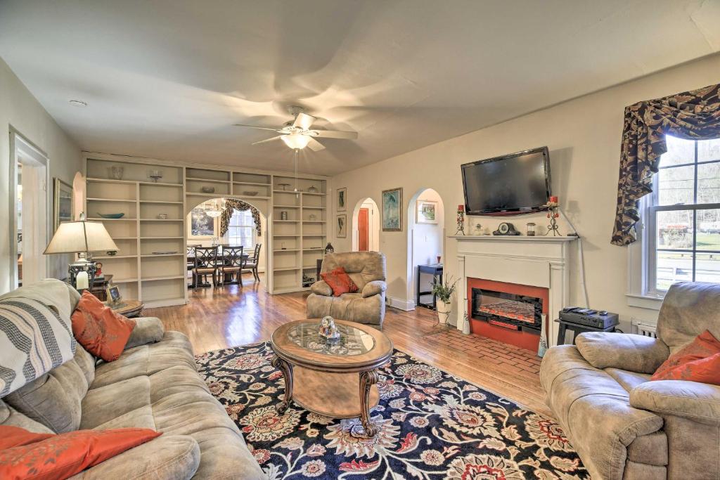 a living room with a couch and a fireplace at Homeplace with Yard - 10 Mi to Jenny Wiley! in Paintsville