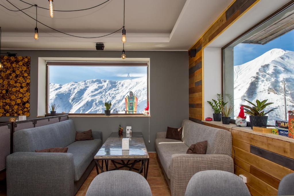 a restaurant with a view of a snowy mountain at Veranda Hotel in Gudauri