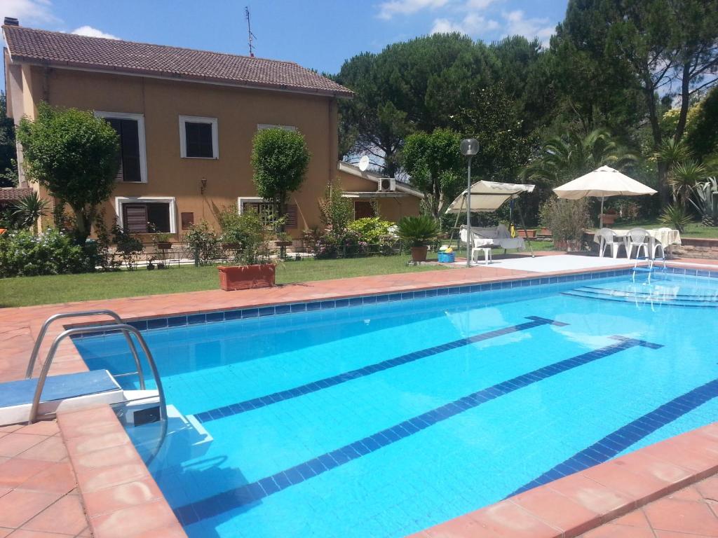 a swimming pool in front of a house at AmbraBed Lunghezza Station in Lunghezza