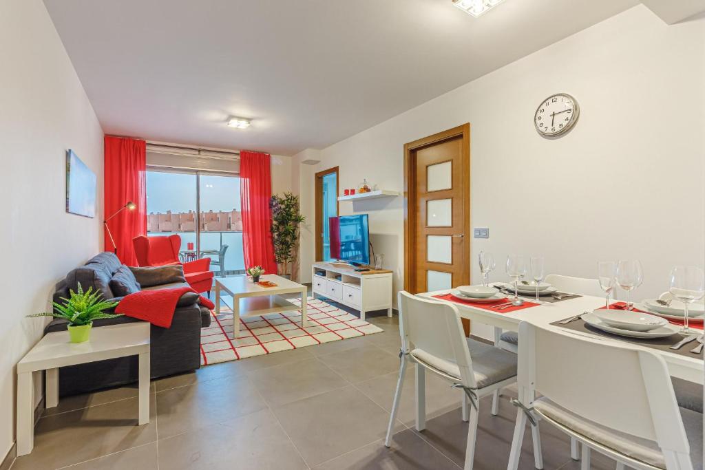 a dining room and living room with a table and chairs at El Medano, La Tejita in El Médano