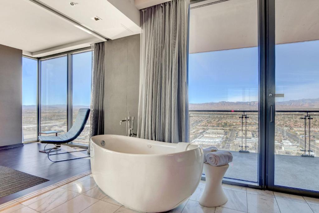 a large bathroom with a tub and large windows at Private Luxury Panoramic Suite at Palms Place in Las Vegas