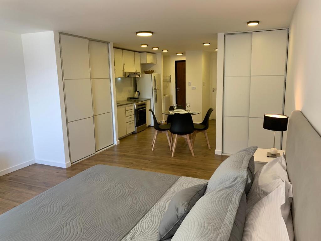 a living room with a bed and a kitchen at Baires Apartament in Buenos Aires