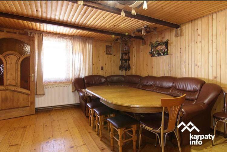 a room with a table and leather chairs and a couch at Карпатська Модрина in Kosiv