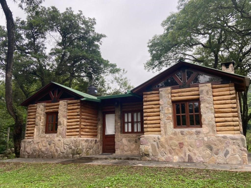 a log cabin with a porch and windows at Casa IMA in San Lorenzo