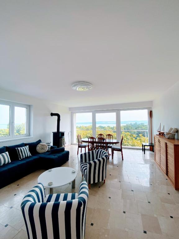 a living room with a couch and chairs and a table at Tihany Panorama House in Tihany