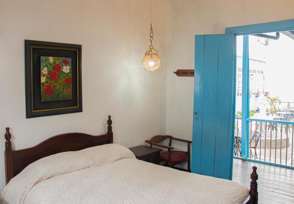 Llit o llits en una habitació de Casa Hotel El Compadre
