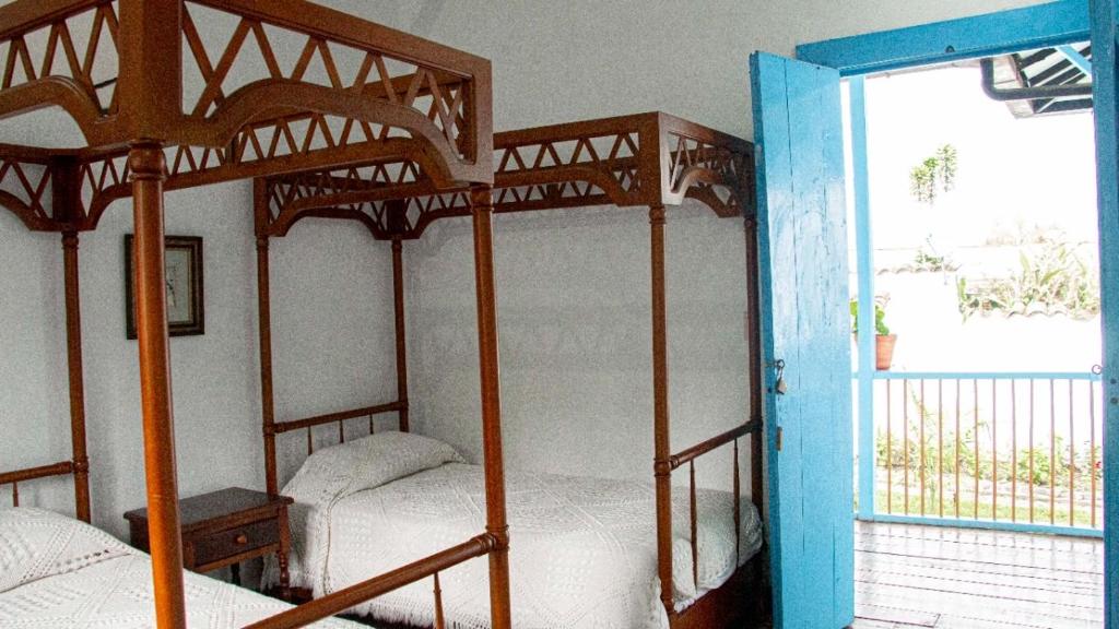 Llit o llits en una habitació de Casa Hotel El Compadre