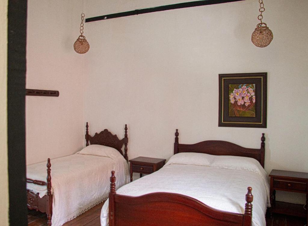 Llit o llits en una habitació de Casa Hotel El Compadre