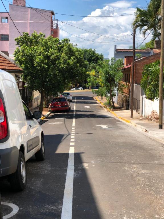 an empty street with cars parked on the side of the road at Chepoya Apart in Posadas