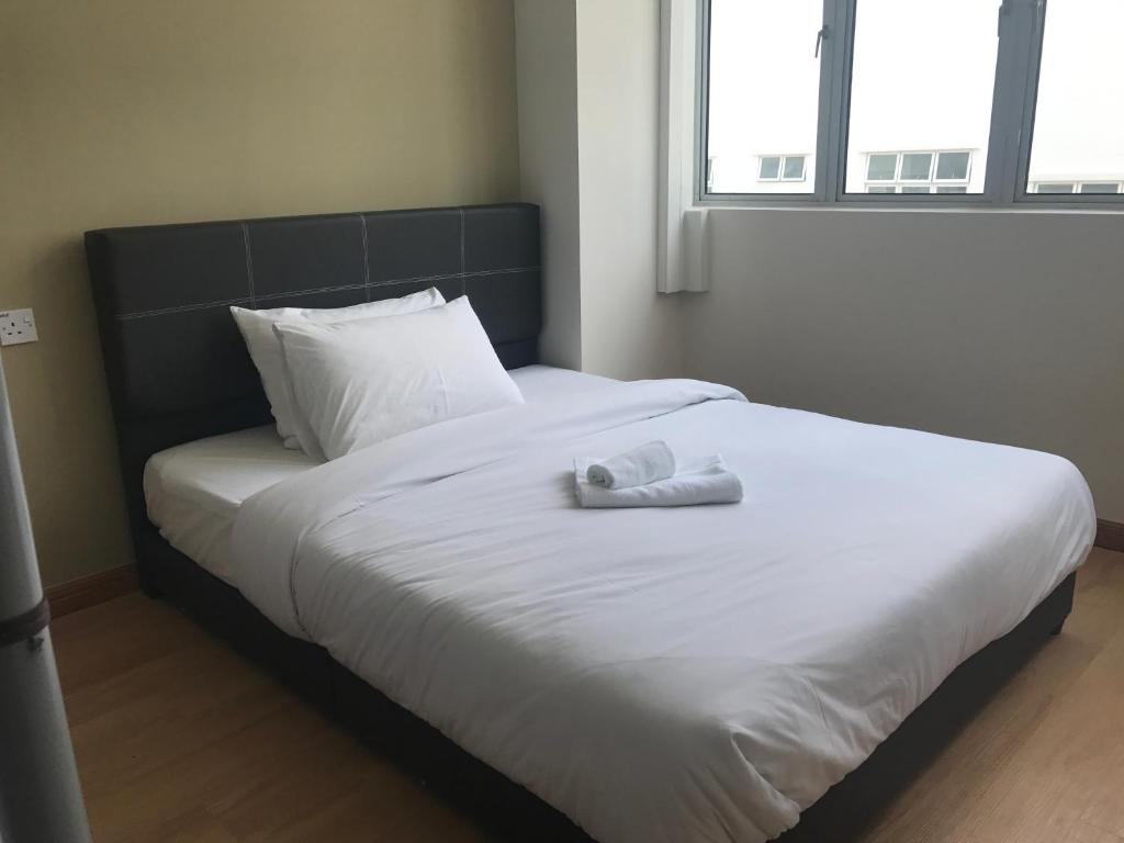Postel nebo postele na pokoji v ubytování Gem Hotel Nusa Sentral Nusajaya