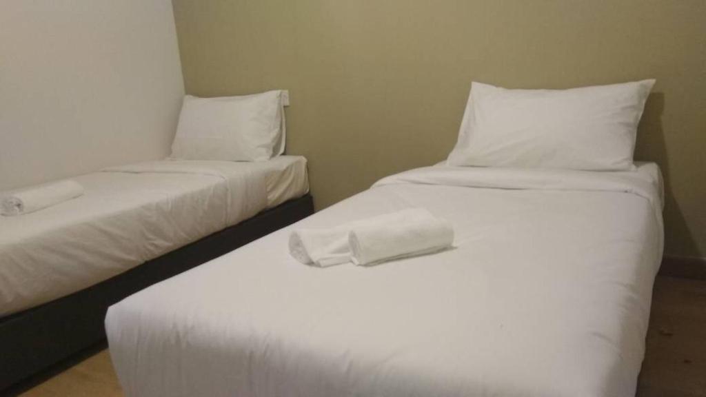 Postel nebo postele na pokoji v ubytování Gem Hotel Nusa Sentral Nusajaya