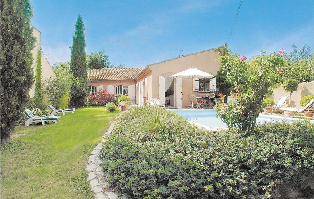 a house with a yard with a swimming pool at Beautiful Home In Lisle Sur La Sorgue With 2 Bedrooms, Private Swimming Pool And Outdoor Swimming Pool in LʼIsle-sur-la-Sorgue