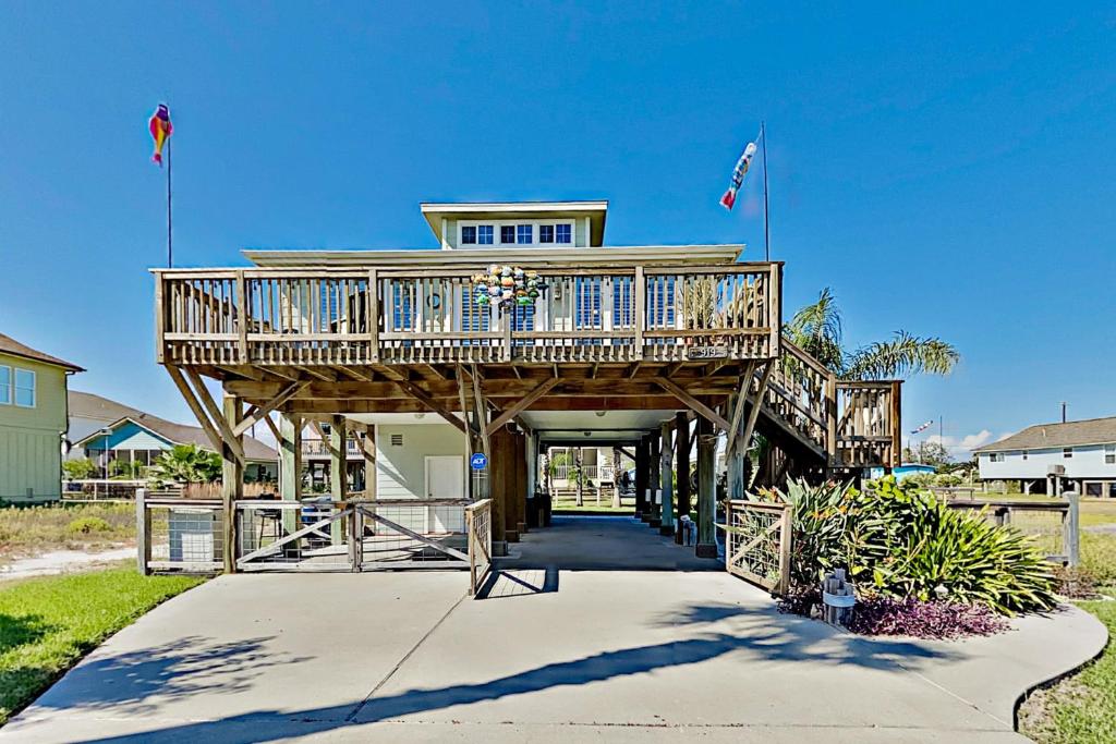 a large house with a deck on a beach at Festive Beach Retreat in Rockport