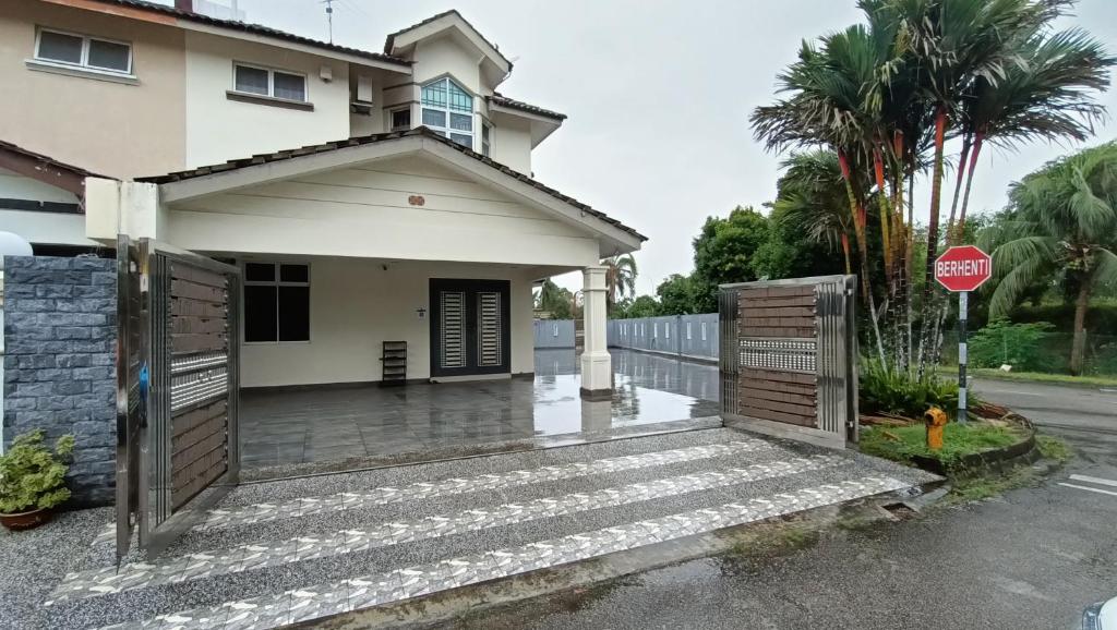 a house with a gate and a stop sign at Party/Gathering Semi-D House @Nusajaya Skudai Johor By Popeye Homestay in Skudai