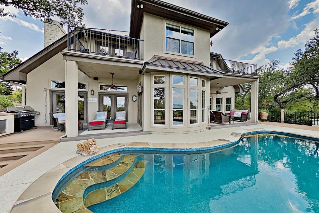 a house with a swimming pool in front of a house at Sacred Vista in Horseshoe Bay