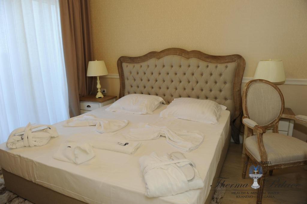 A bed or beds in a room at Therma Palace - All inclusive & Private Beach & Free Parking