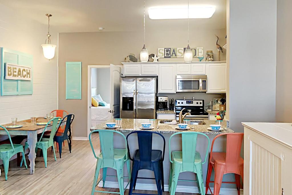 a kitchen and dining room with a table and chairs at Ocean Pulse in Corpus Christi