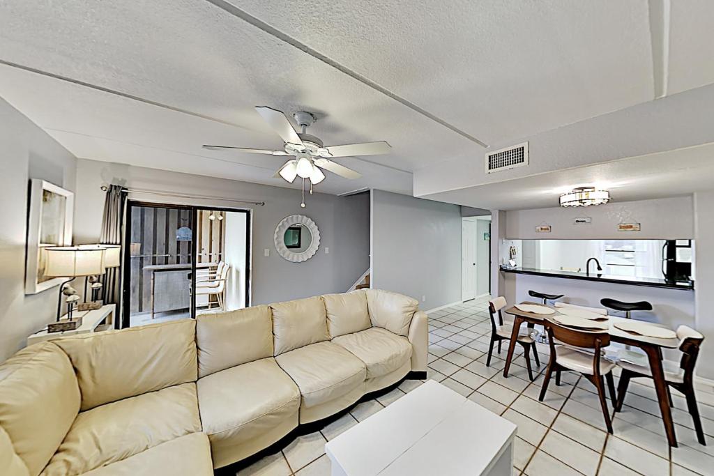 a living room with a couch and a table at Habitat Condos in South Padre Island