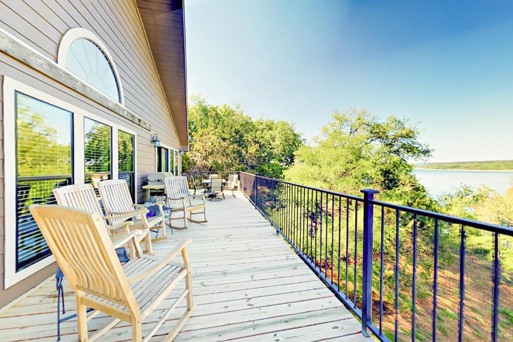 a porch with rocking chairs and a view of the water at Coventry Casa in Spicewood