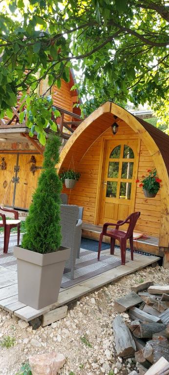 una piccola cabina in legno con panchina e albero di Vila Jelena - BUNGALOV a Crni Vrh