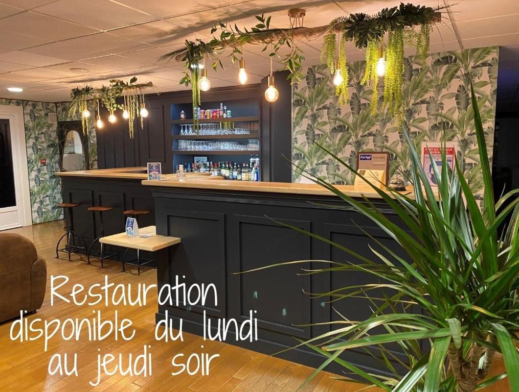a bar in a restaurant with a plant at SHELDER Hôtel - CHERBOURG EN COTENTIN - Equeurdreville in Cherbourg en Cotentin