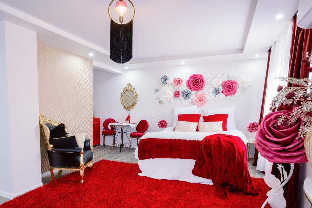 a red and white bedroom with a bed and a table at Suite Romantique in Hésingue
