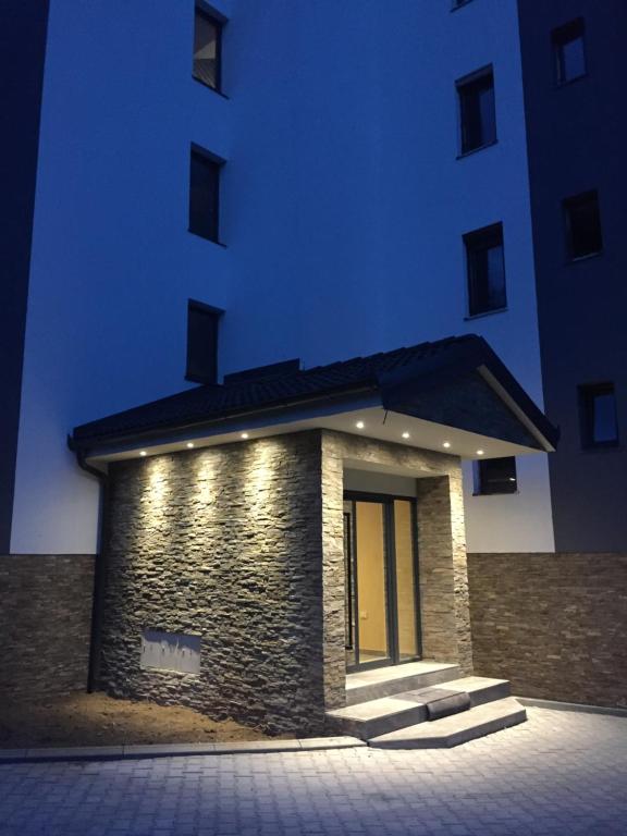 a building with a lighted entry way in front of it at Apartman TIO Binis in Zlatibor