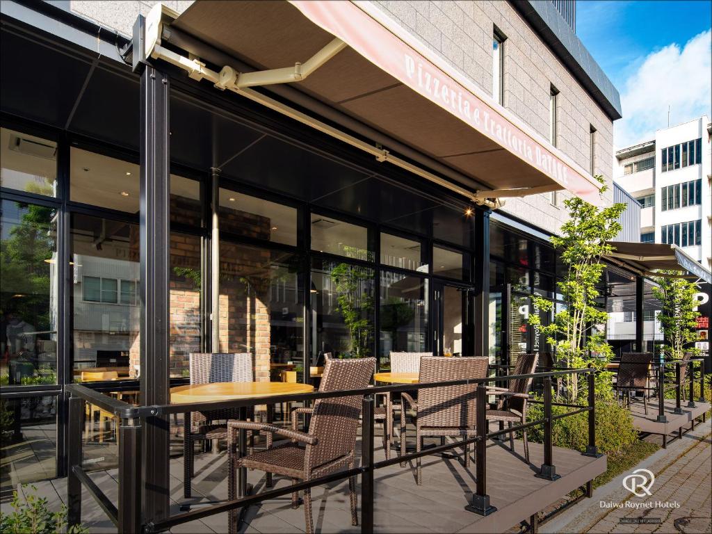 an outdoor patio with a table and chairs at Daiwa Roynet Hotel Kanazawa Eki Nishiguchi in Kanazawa