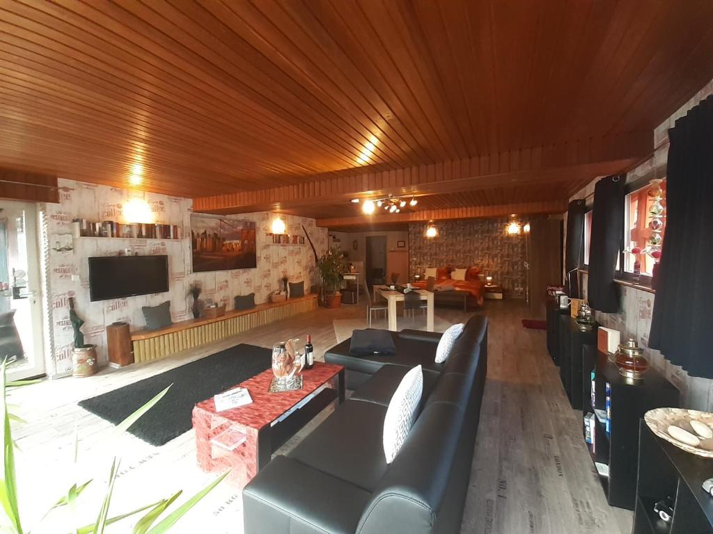 a large living room with couches and a television at Ferienwohnung Atlantis in Hemfurth-Edersee