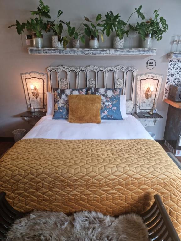 a bedroom with a large bed with blue pillows at La Casa Nostra Villa Rose Garden Carmella in Hillcrest