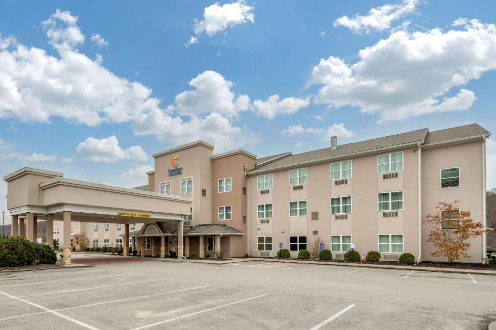 un hotel con un estacionamiento delante de él en Comfort Inn & Suites Northern Kentucky, en Wilder