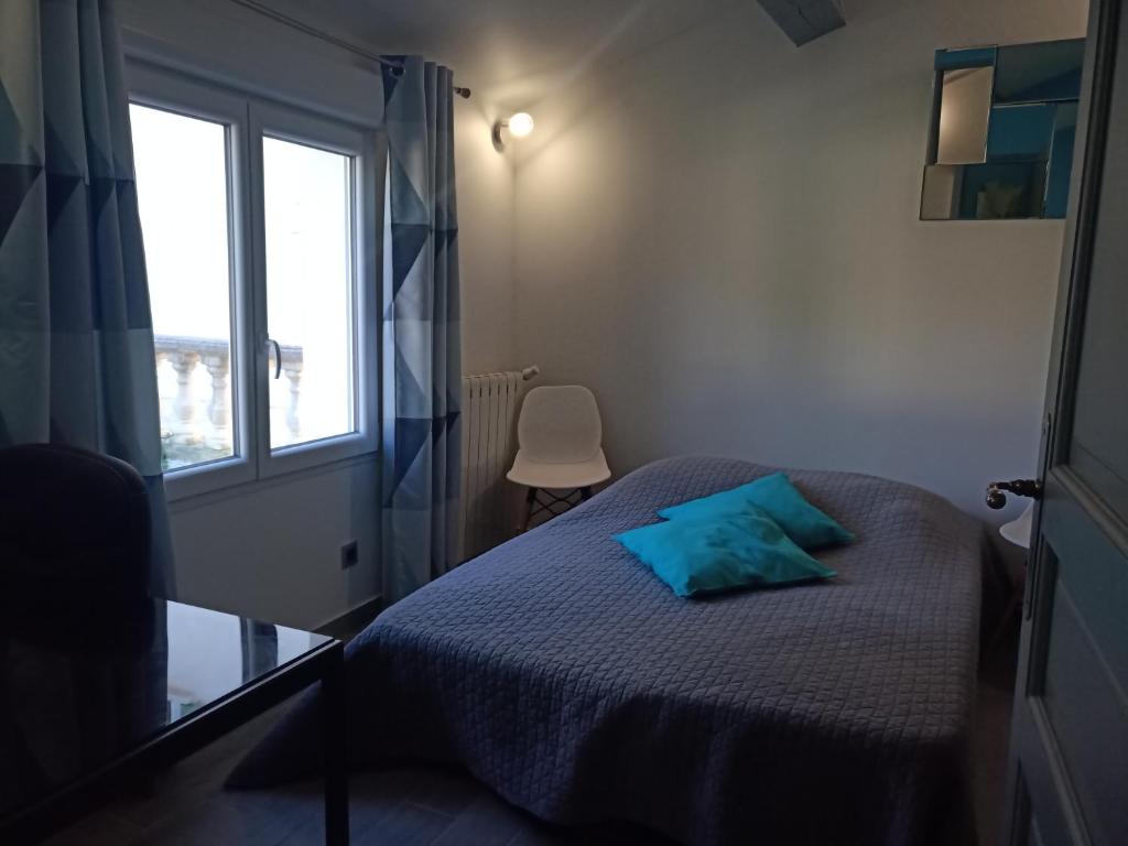 a small bedroom with a bed and a window at Sur les pas de Pagnol in Aubagne