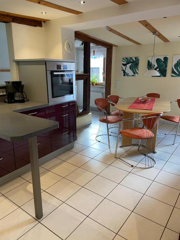 a kitchen with a table and chairs and a dining room at Super große Ferienwohnung für bis zu 5 Personen in Owen
