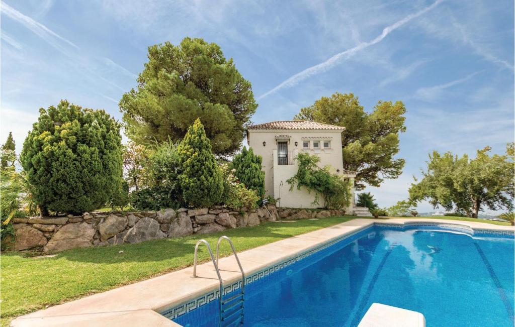 a villa with a swimming pool and a house at El Peascal in Marbella