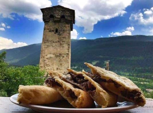 a plate of food with sandwiches on a table at Guesthouse Kurdiani in Mestia in Mestia