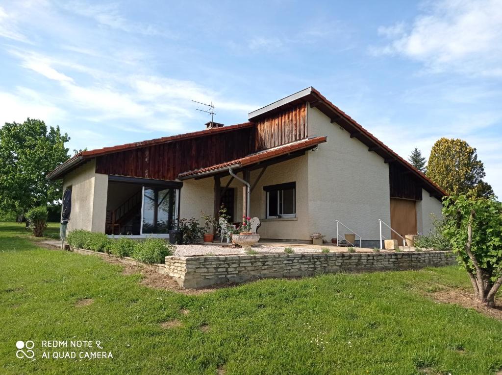 Casa blanca pequeña con techo de madera en Gîte A-B Roger en Ganties