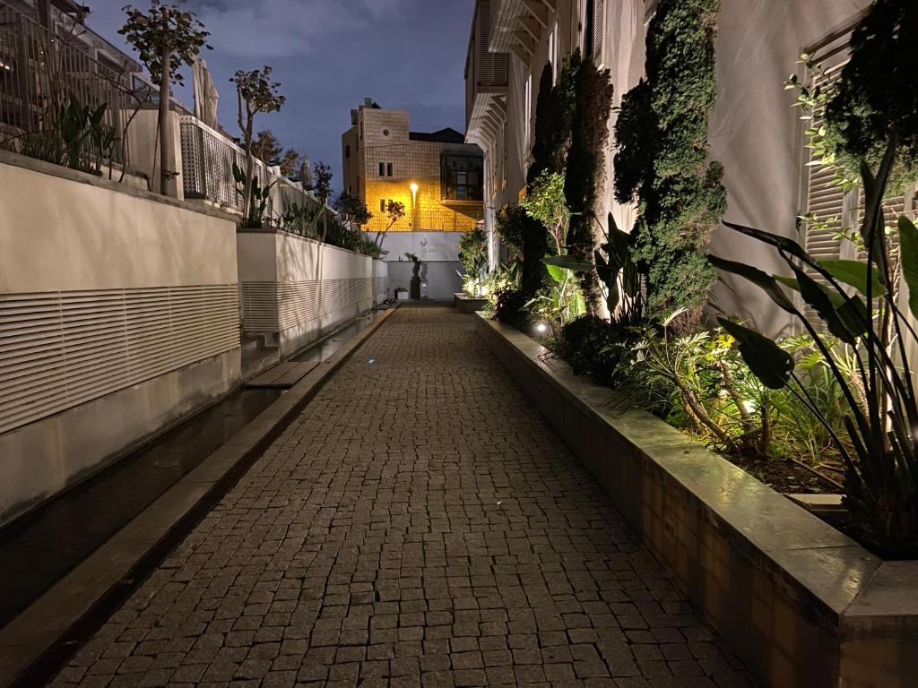 a cobblestone alleyway in a city at night at Laura Compound- Authentic 1 BR charming & specious in Tel Aviv