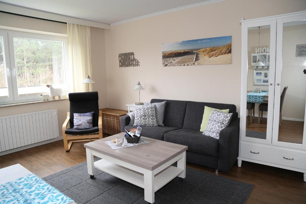 a living room with a couch and a coffee table at Möwennest in Sankt Peter-Ording