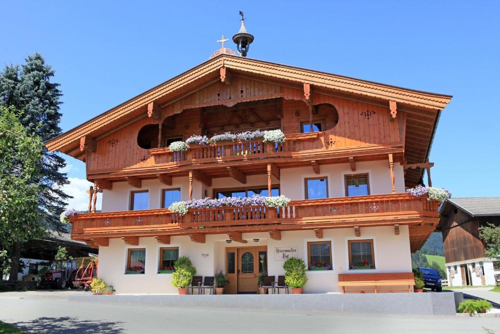 a large wooden building with a balcony at Starmacher Hof in Itter