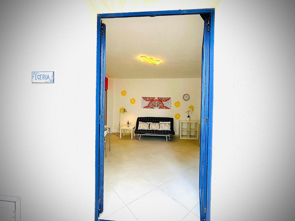 an open door to a living room with a couch at Casa Serra in Porto Palo